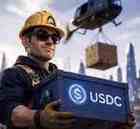 Builder in yellow Arc hard hat carrying a USDC crate on a futuristic jobsite